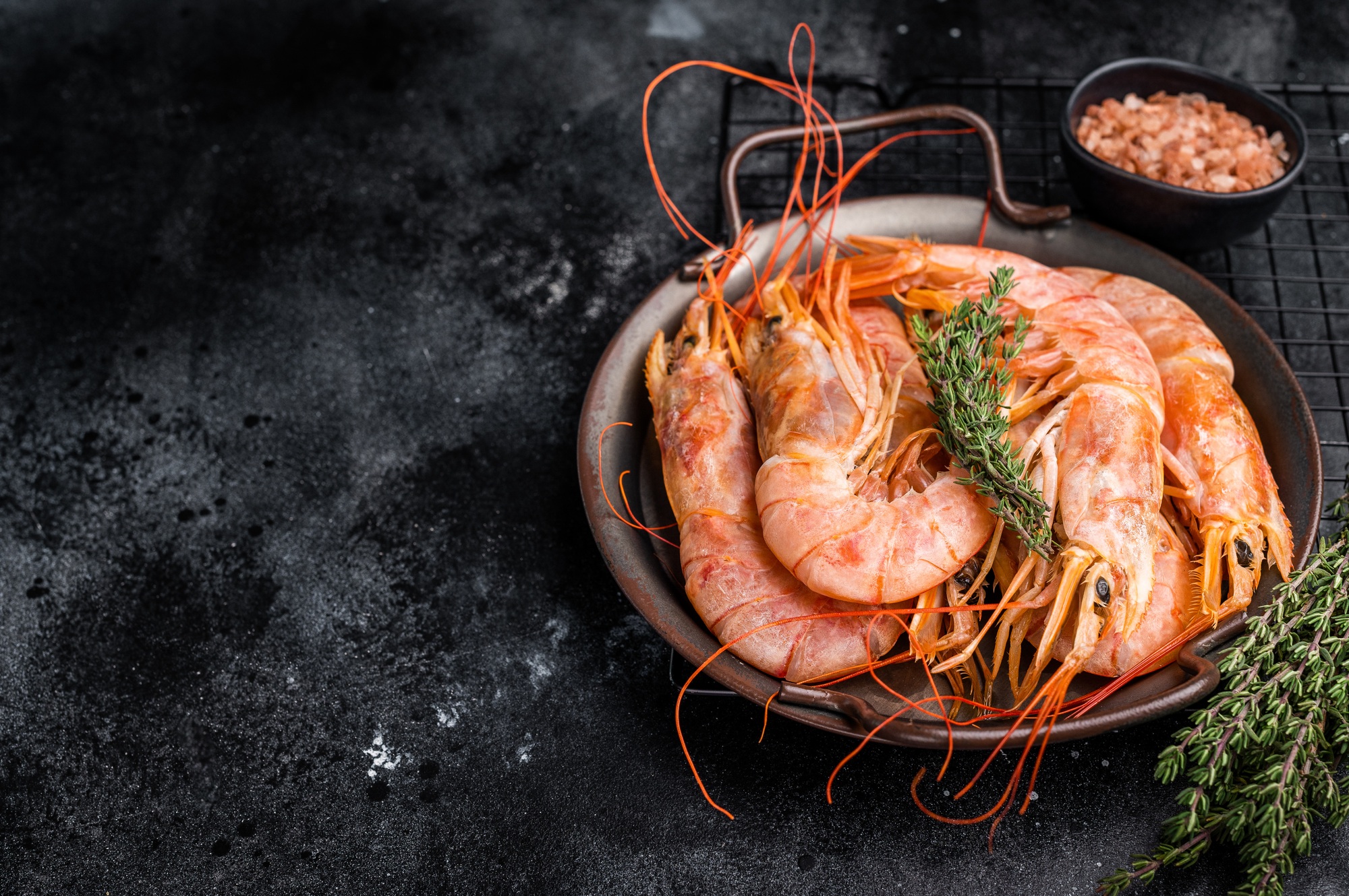Red Argentine shrimps, raw Prawns Langostino Austral in steel tray. black background. top view